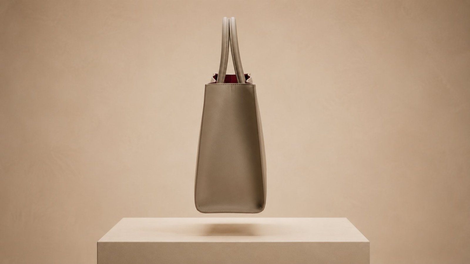Pure side profile of the tote, showing the tapered gusset narrowing from the opening to the base.