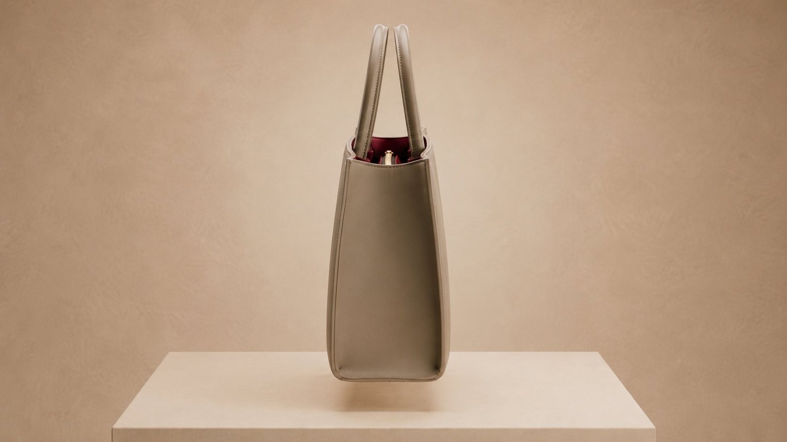 Side profile with the tote standing on the plinth, holding its shape without support.